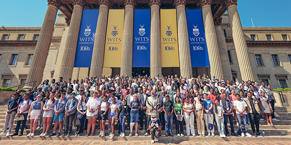Top Applicant's from the Class of 23 take a picture on the steps of the Great Hall.